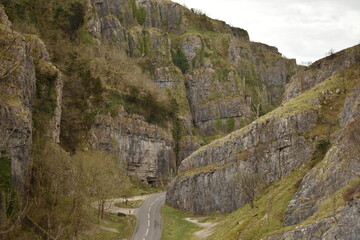 Looking down from hillside at a road cutting through the dramatic Cheddar Gorge