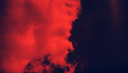 Grunge image of sky with a red cloud on grainy film texture