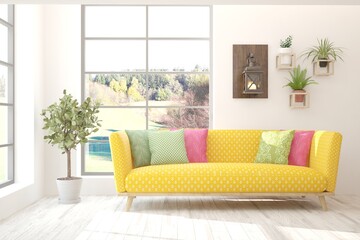 Stylish room in white color with sofa and autumn landscape in window. Scandinavian interior design. 3D illustration