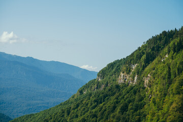 natural wallpaper with high mountains in fog and green hill