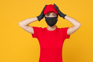 Delivery employee woman in red cap blank t-shirt uniform protect face mask gloves working courier in service during quarantine coronavirus covid-19 virus isolated on yellow background studio portrait.