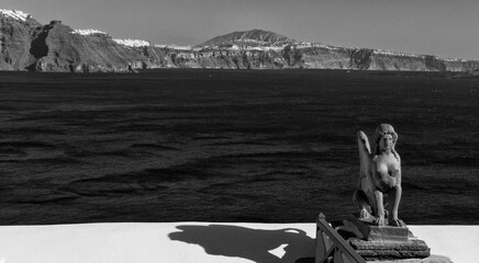 A black and white view of Santorini's caldera with a sphynx