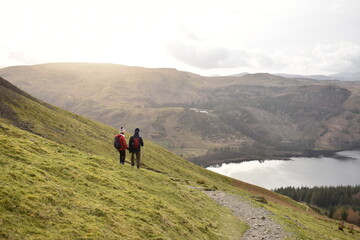 Fototapeta na wymiar A couple trekking together Helvellyn Lake District