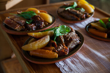 Tasty food serving in restaurant, potato slices with pork meat