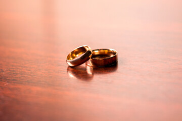 Gold wedding rings on a wooden background.Wedding attributes. Wedding ceremony