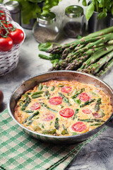 Frittata made of eggs, asparagus and tomatoes