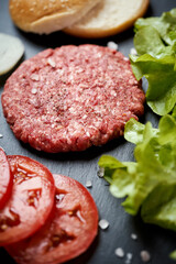 fresh beef for burger on the table with lettuce onion and bread