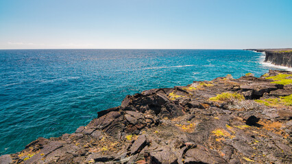Cliffs on the seashore. Large boulder among the waves in the sea. Hawaii