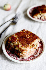 Apple and Cheese Cobbler Crisp. Cobbler or Crumble dessert with apples on plates on beige linen table. Selective focus