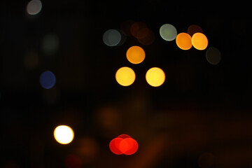 Night city lights bokeh. City illumination. Dark background