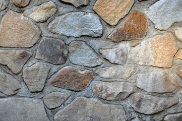decorative wall made of stones and concrete background