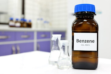 Selective focus of benzene liquid chemical compound in dark glass bottle inside a chemistry...