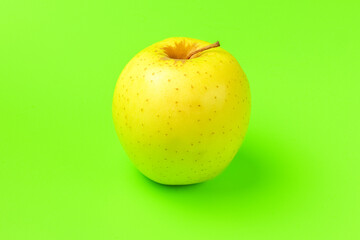 yellow Apple on a green background close-up.isolate