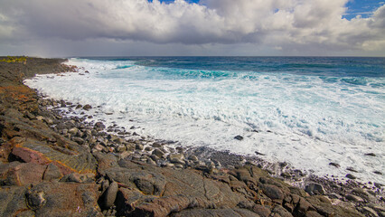 Beautiful shore. Large boulder among the waves in the sea. Hawaii