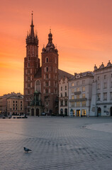 Fototapeta na wymiar Main square with St Mary's church, colorful sunrise, Krakow, Poland