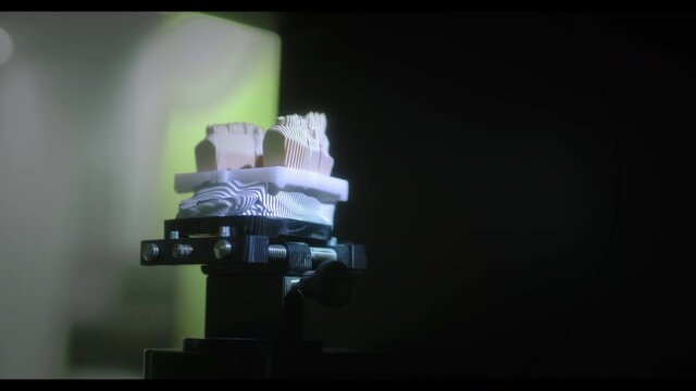 3D scanning of a plaster cast of the jaw. Modern dental technology. Ultraviolet rays travel through the teeth.