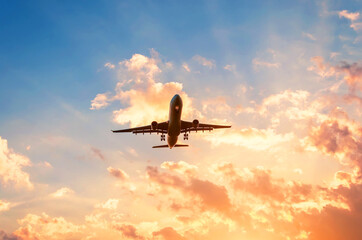 Travel by plane in a beautiful sky at sunset with clouds.
