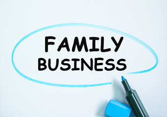 Check list and marker. Definition of the word FAMILY BUSINESS highlighted with with a marker. partial focus