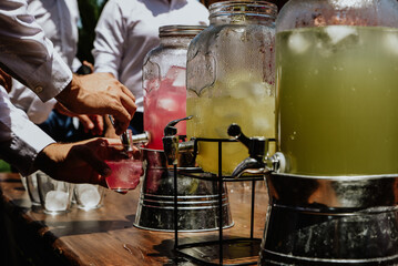 guest of an event serving a drink from the open bar of cocktails on a sunny summer day