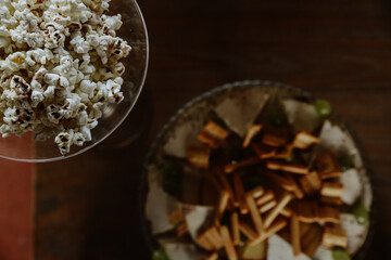 close up of a popcorn. Salty table for an event with popcorn, cheese, bread