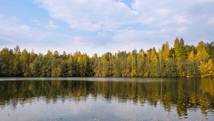 Autumn landscape of Karelian forest, lake and sky