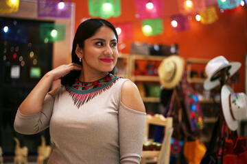 beautiful smiling mexican woman in traditional mexican dress hands up holding the skirt as a background like peacock, neckless , morena de fuego luces, papel picado