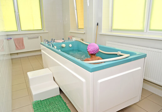 The child takes a treatment bath in the water clinic of the children's sanatorium