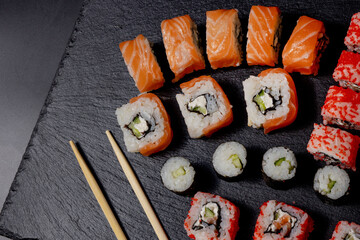 Set of sushi roll on black slate background food fish philadelphia japanese salmon delicious sushi rice cucumber meal traditional wasabi fresh healthy gourmet raw cuisine