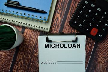 Microloan write on a paperwork isolated on office desk.