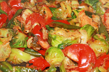 Stir fry of Brussel sprouts, tomatoes and peppers in spicy sauce
