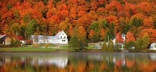 Panoramic view of old barn by the lake with fall foliage near Danville, Vermont
