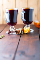 Mulled wine on a wooden boards. Autumn mulled wine, spices and honey. Christmas hot drink in rustic style