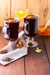 Mulled wine on a wooden boards. Autumn mulled wine, spices and honey. Christmas hot drink in rustic style