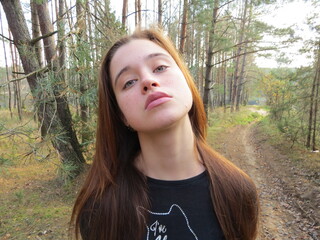 Redhead girl in autumn forest