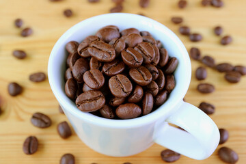 Cup of Roasted Coffee Beans on Wooden Background