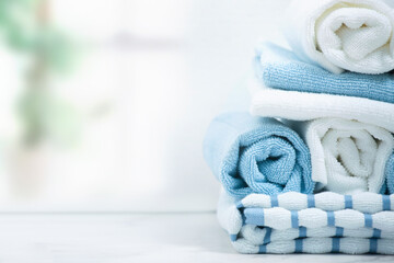 Towels rolled and stacked on table top view.Shower towel empty space background.
