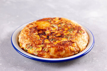 Delicious potato tortilla with vegetables with herbs