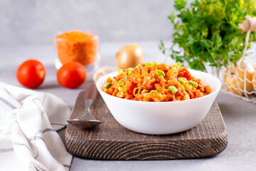 Vegetarian lentil stew in a bowl on light background. Traditional turkish or arabic lentil and vegetable spicy soup, healthy vegan food.