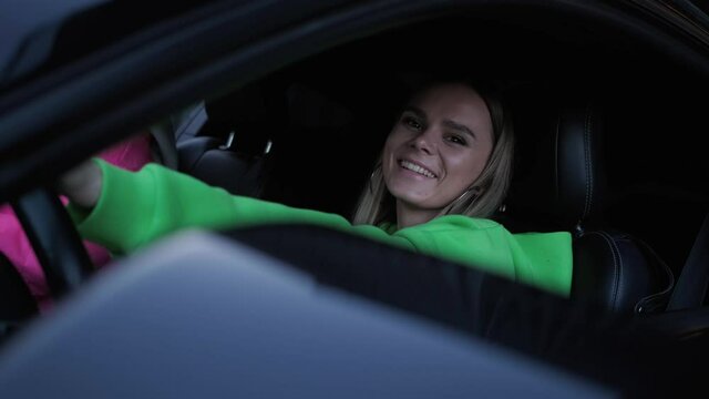 the girl behind the wheel of a car.beautiful funny girls in the car.
