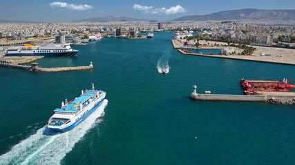 Fototapeta na wymiar Aerial drone photo of passenger ferry cruising in high speed and entering famous port of Piraeus, Attica, Greece