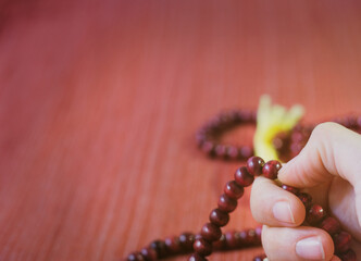 Female hands holding buddhist mala rosary