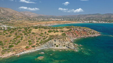 Aerial drone photo of famous islet, beach and bay of Agios Nikolaos in Anavysos area with crystal clear emerald sea, Athens riviera, Attica, Greece