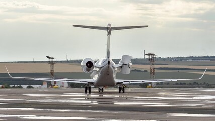 Side view of white business jet with turbofan engines at the airport. Modern technology in fast transportation, business travel and tourism, aviation concept.