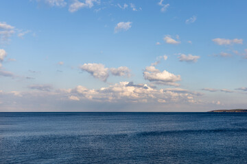 Calm sea landscape with beautiful clouds and mountains 