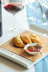 Spanish empanadas with sauce on restaurant table