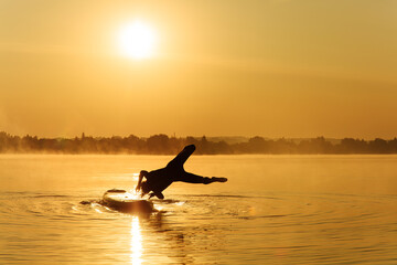 Sporty man lost balance on board and falling down into lake