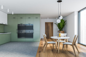 Panoramic white and green kitchen with dining table