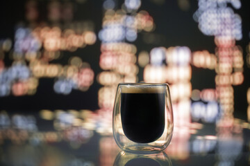 Glass of coffee on the background of the night city