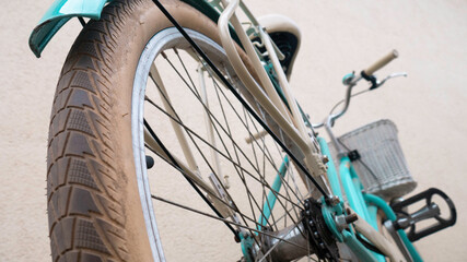 Women's bicycle with a basket photographed from the rear tire.