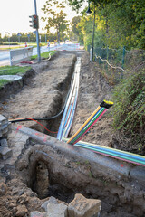 construction site for installing fiber optic cables under the ground for fast internet in a street of a german village, selected focus